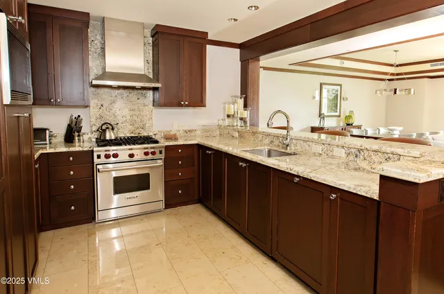 a kitchen with stainless steel appliances granite countertop a stove a sink dishwasher and cabinets