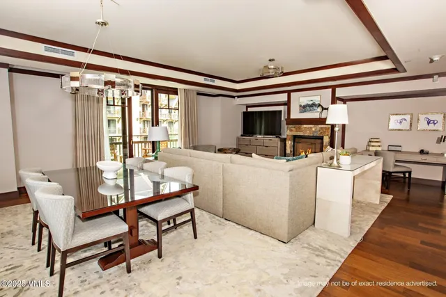 a living room with furniture a flat screen tv and a table