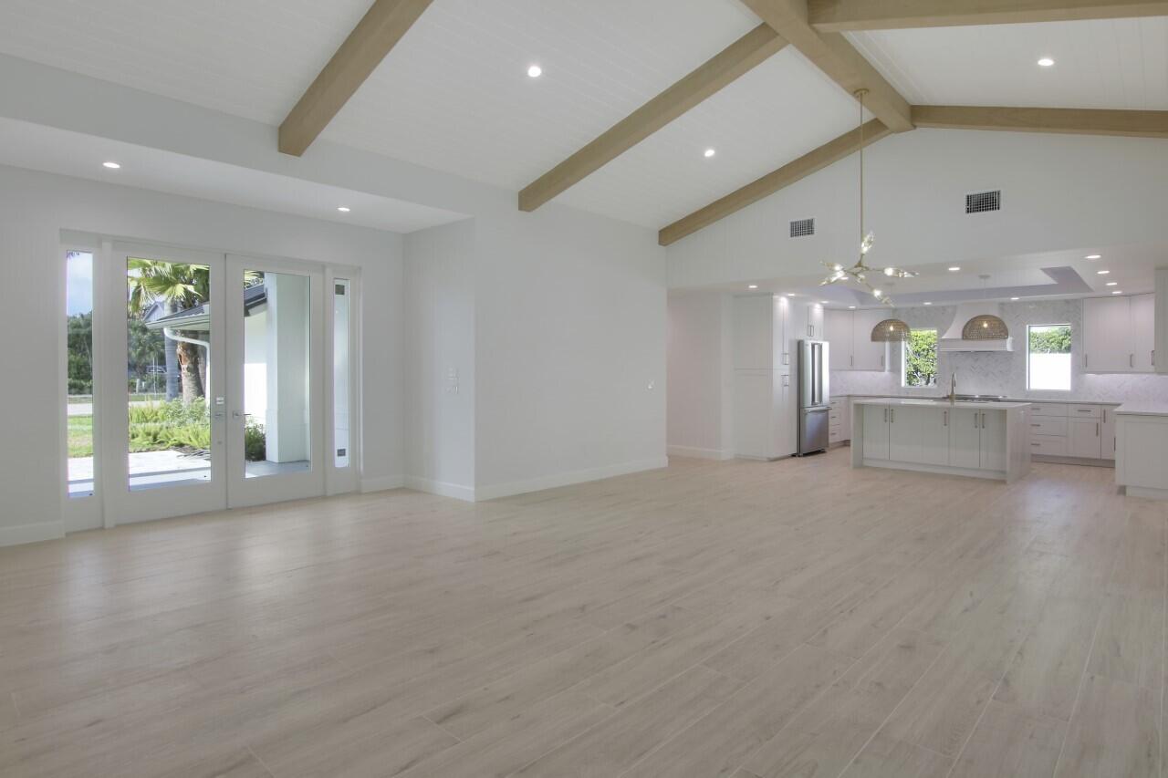 1504 Ocean Way Jupiter, FL 33477 - Photo 5 of 17 a view of a big room with windows and chandelier
