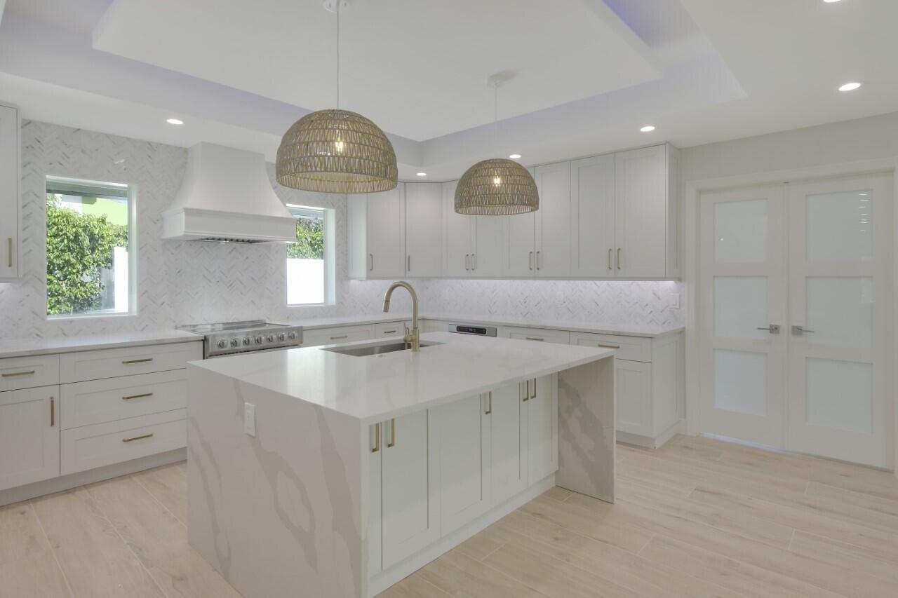 1504 Ocean Way Jupiter, FL 33477 - Photo 8 of 17 a kitchen with a sink cabinets and window