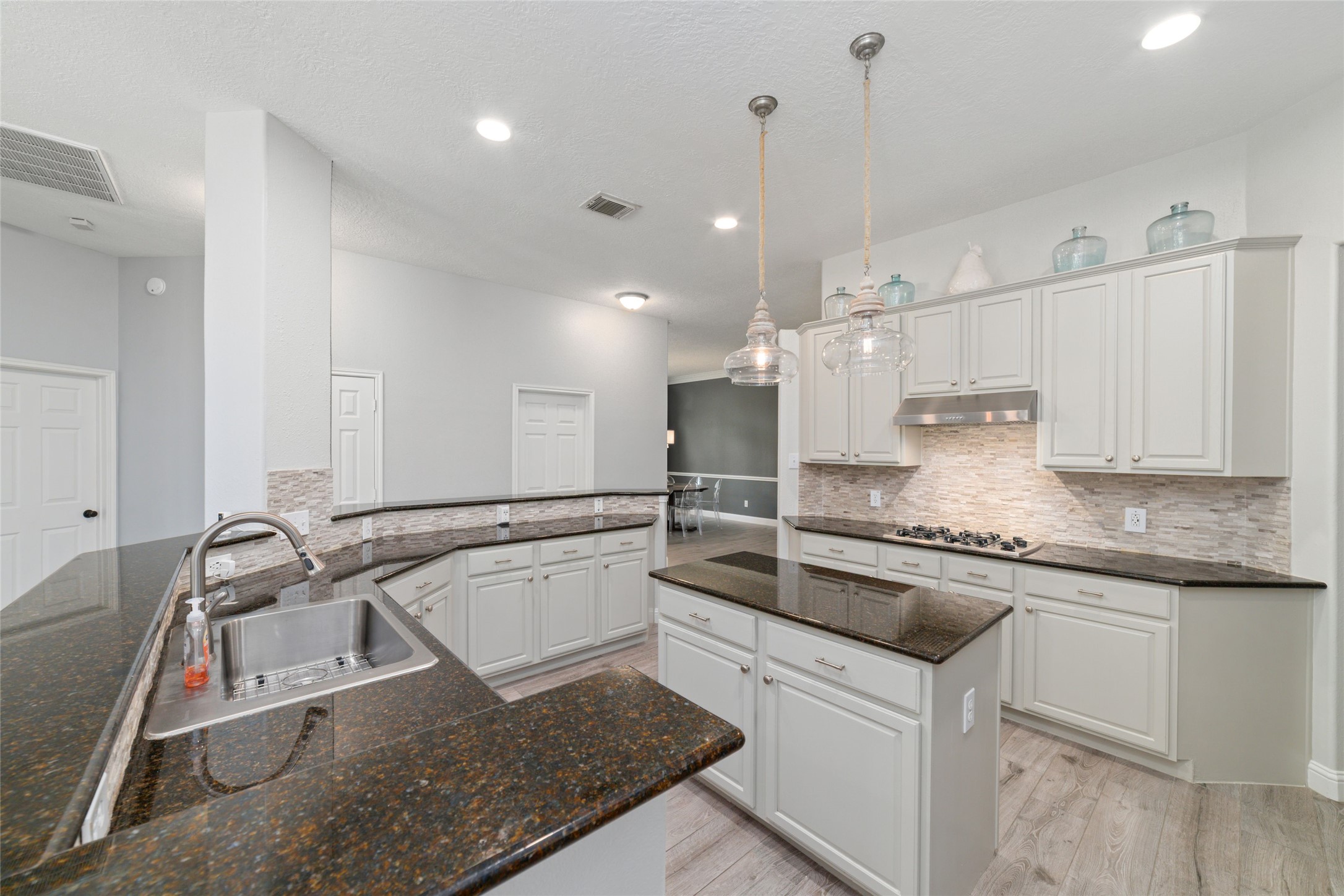 24203 Moon Ridge Court Katy, TX 77494 - Photo 13 of 43 The open layout offers ample workspace and a stylish backsplash, perfect for cooking and entertaining.