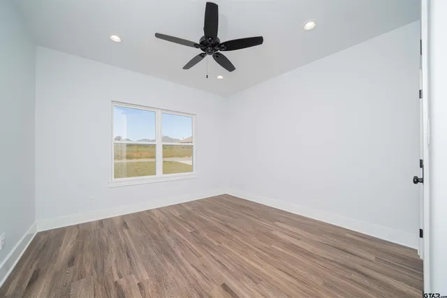 a bathroom with a granite countertop sink a toilet and shower