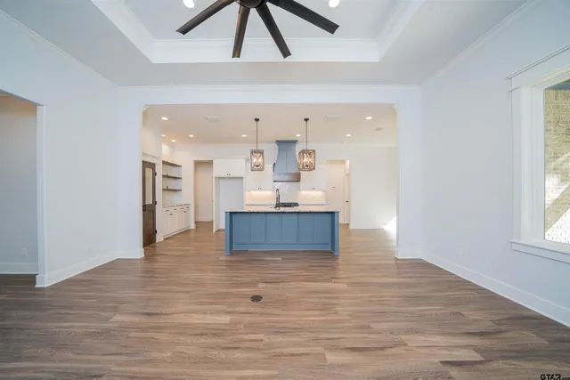 a view of kitchen and hall with wooden floor