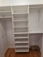 a view of walk in closet with empty racks