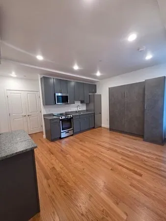 a large kitchen with a stove and a refrigerator