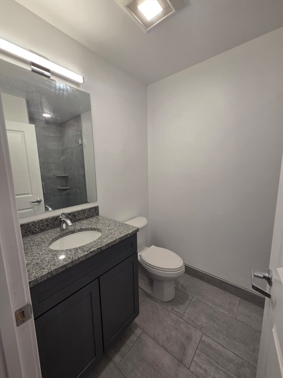 165 Hawthorne Street, Unit 306 Chelsea, MA 02150 - Photo 5 of 11 a bathroom with a granite countertop sink and a mirror