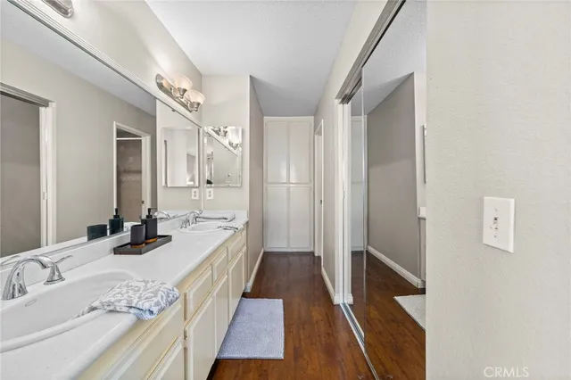 a bathroom with a double vanity sink and a mirror