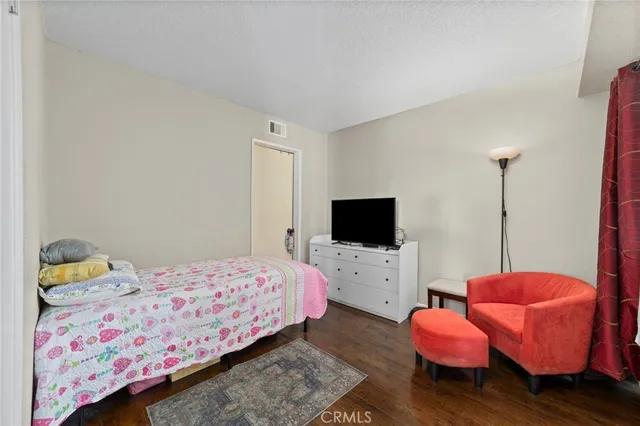 a bedroom with a bed and flat screen tv