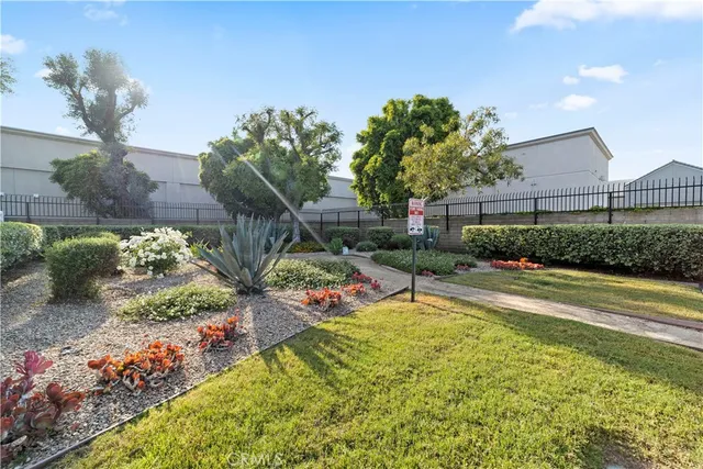 a view of a backyard with plants and lake view