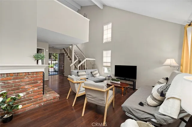 a work room with furniture wooden floor and a flat screen tv