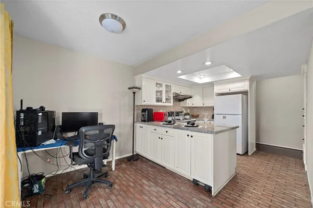 a kitchen with a sink appliances and cabinets