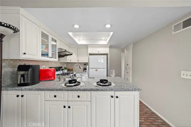 a kitchen with stainless steel appliances granite countertop a sink and cabinets