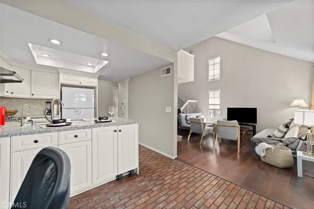 a living room with furniture a fireplace and wooden floor