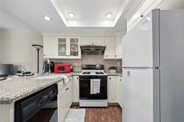 a kitchen with a stove and a refrigerator
