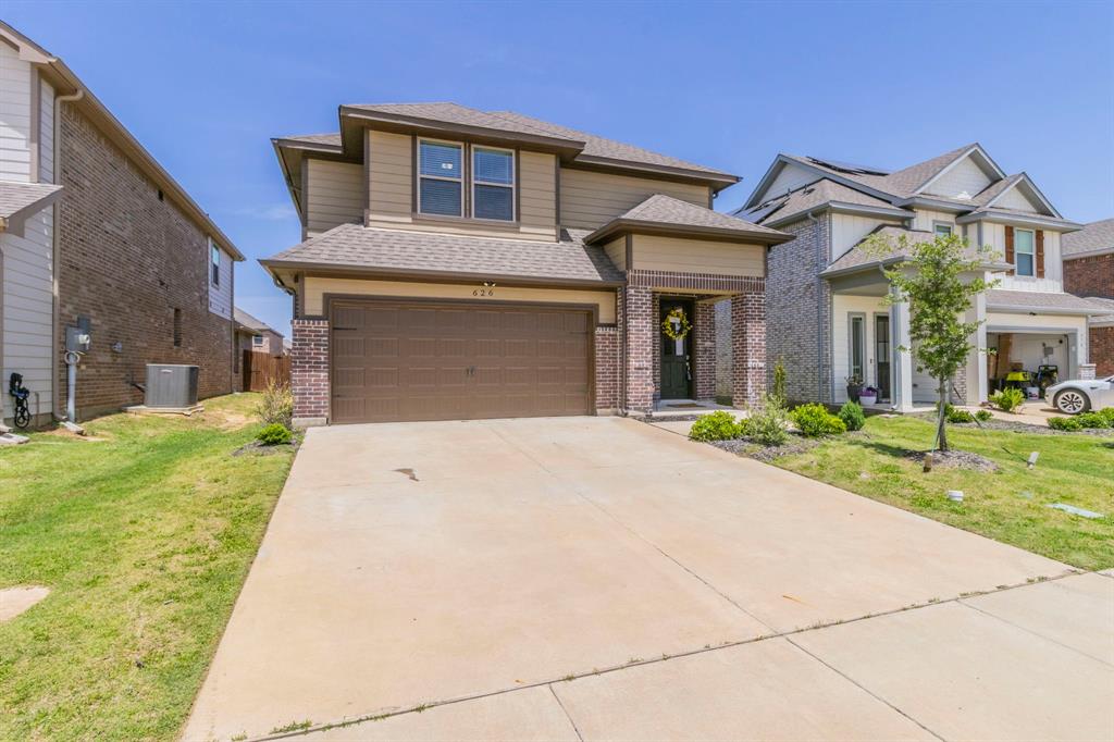 626 Ruthye Lane Pilot Point, TX 76258 - Photo 2 of 27 View of front of property with a front lawn, a shingled roof, brick siding, concrete driveway, and a 2-car garage
