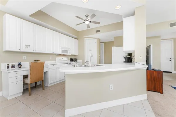 a kitchen with cabinets appliances a sink and a counter top space