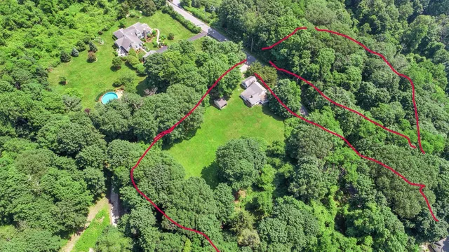 an aerial view of a house with a yard