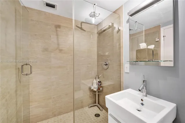 a bathroom with a granite countertop shower and a toilet