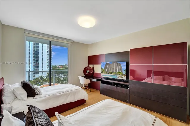 a living room with furniture and floor to ceiling windows