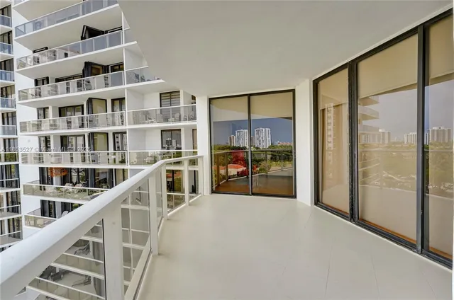 a view of a living room and floor to ceiling window or kitchen