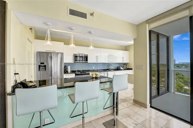 a bedroom with a bed couch and a large window