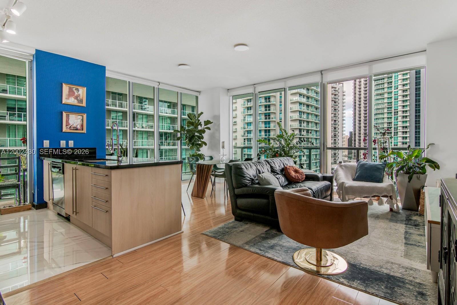 79 Southwest 12th Street, Unit 2107S Miami, FL 33130 - Photo 1 of 47 a living room with furniture and a potted plant