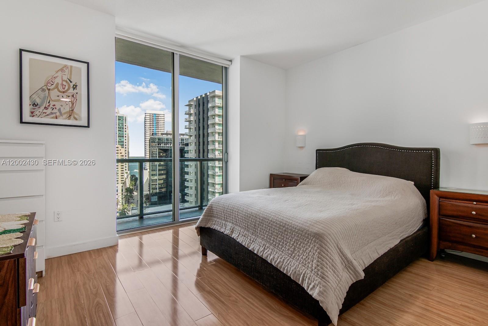 79 Southwest 12th Street, Unit 2107S Miami, FL 33130 - Photo 20 of 47 a bedroom with a large bed and a large window