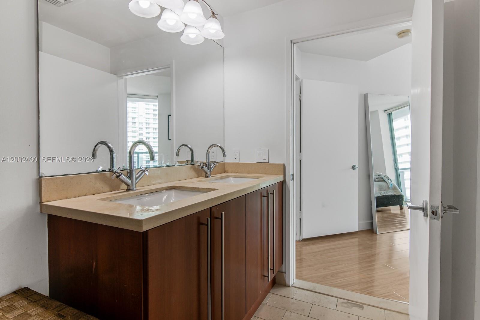 79 Southwest 12th Street, Unit 2107S Miami, FL 33130 - Photo 24 of 47 a bathroom with a sink and a mirror