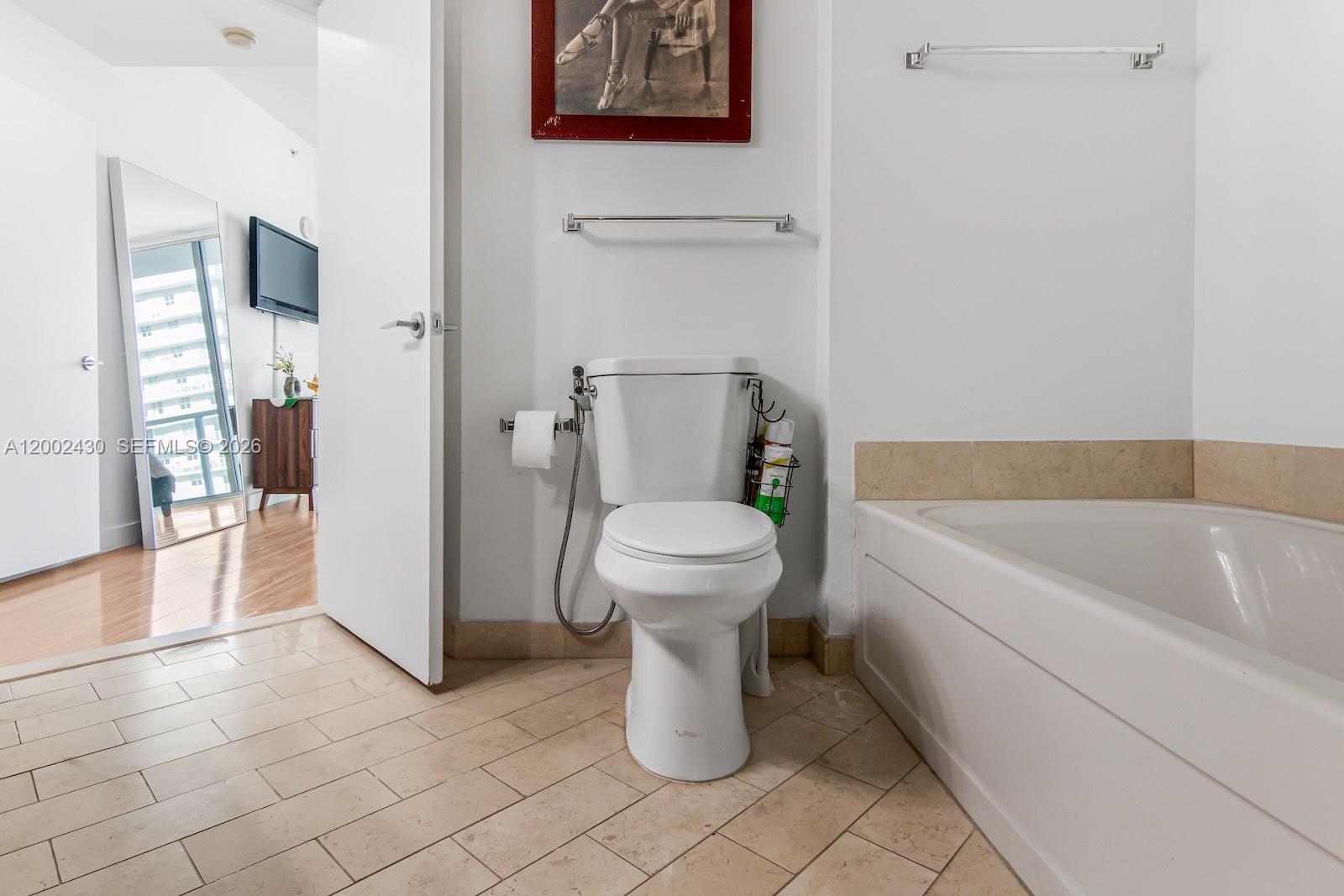 79 Southwest 12th Street, Unit 2107S Miami, FL 33130 - Photo 25 of 47 a bathroom with a toilet and a bathtub