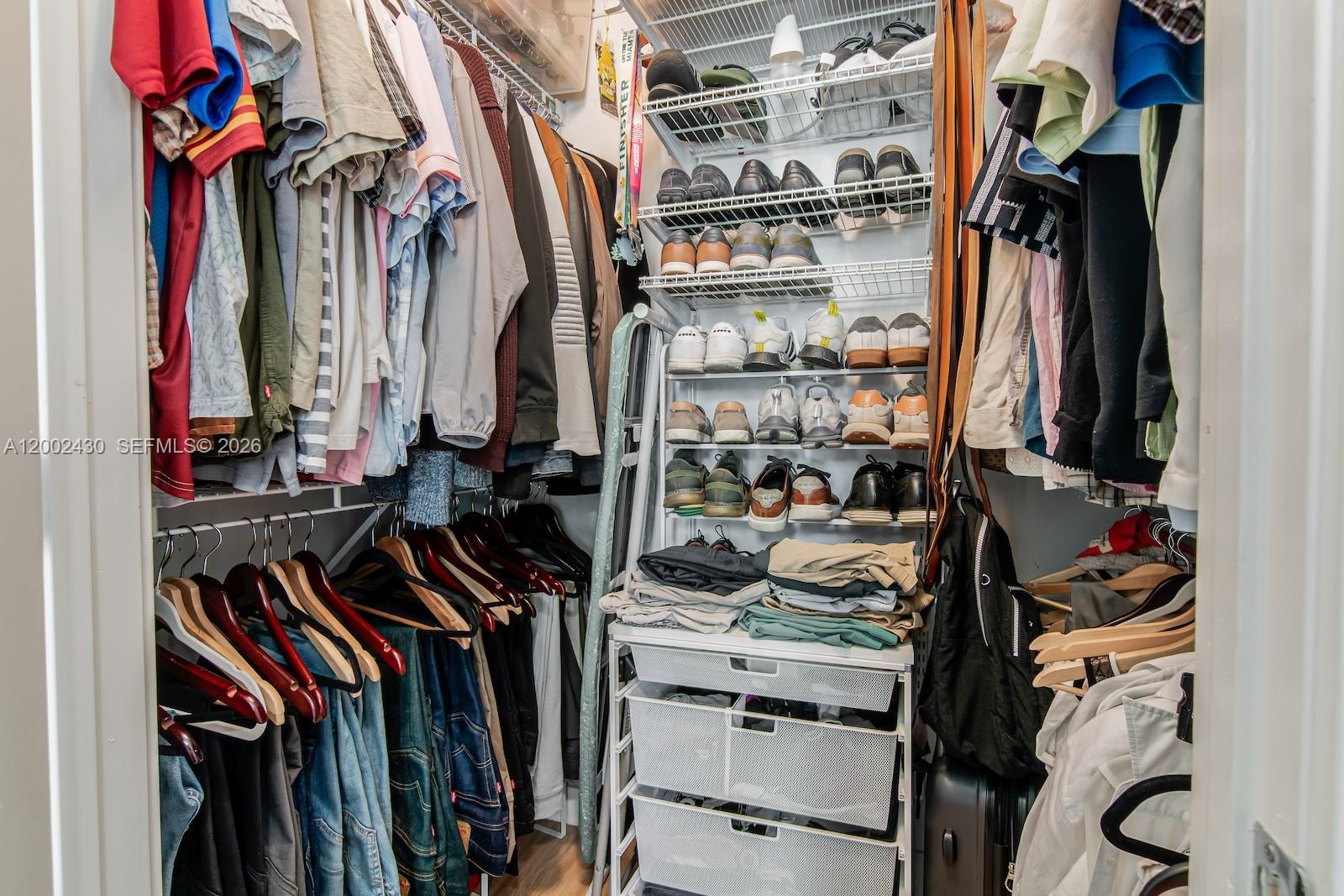 79 Southwest 12th Street, Unit 2107S Miami, FL 33130 - Photo 26 of 47 a view of walk in closet with clothes and shoes