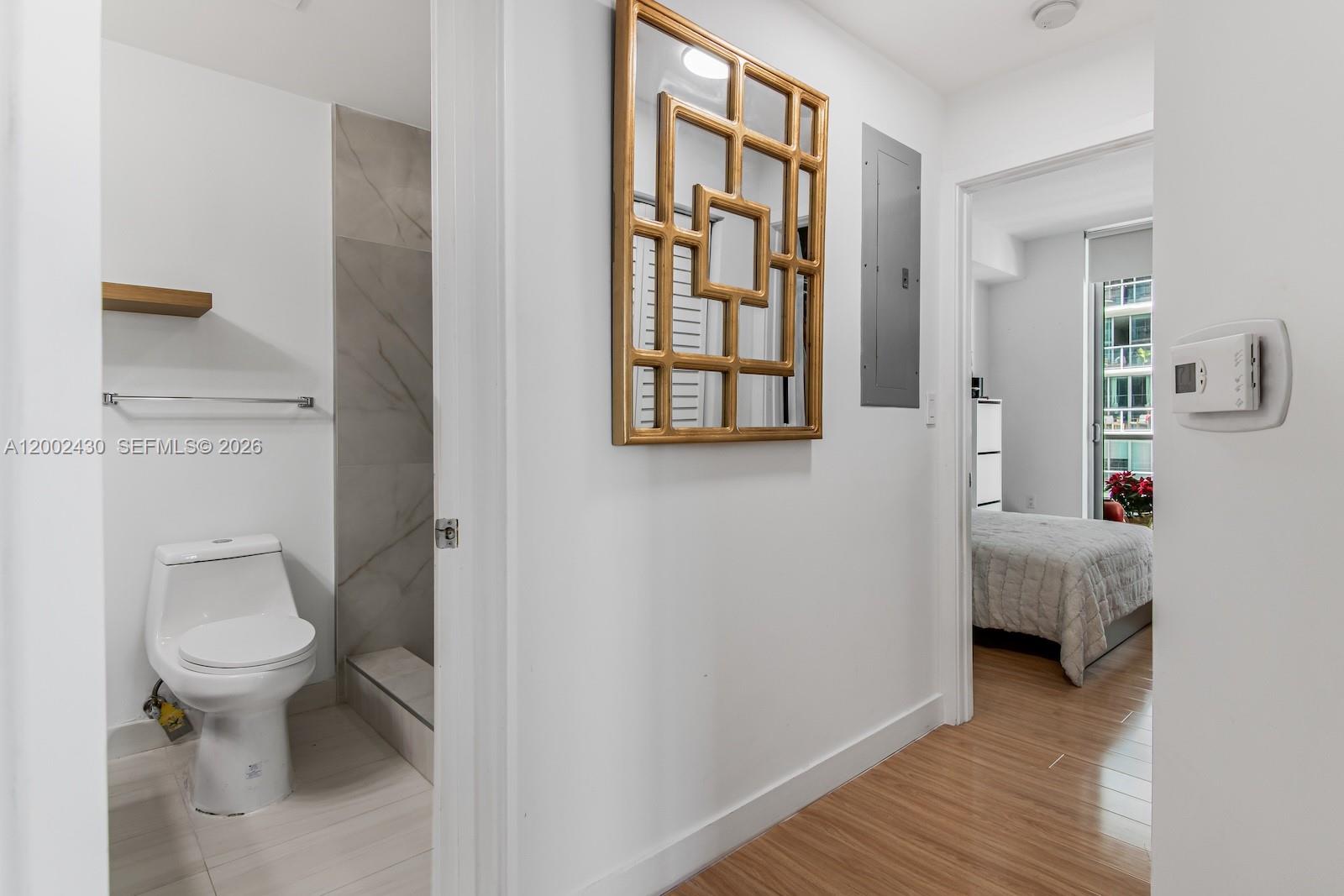 79 Southwest 12th Street, Unit 2107S Miami, FL 33130 - Photo 28 of 47 a spacious bathroom with a toilet a sink and a window