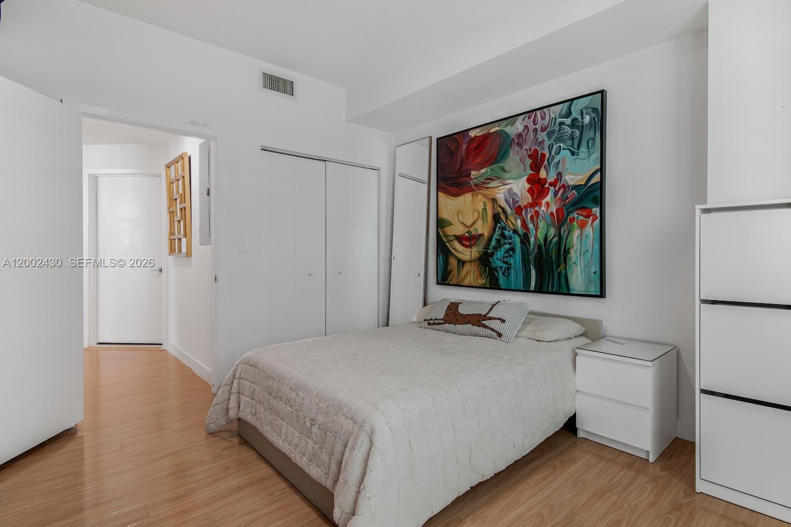 79 Southwest 12th Street, Unit 2107S Miami, FL 33130 - Photo 31 of 47 a bedroom with a bed and a flat screen tv