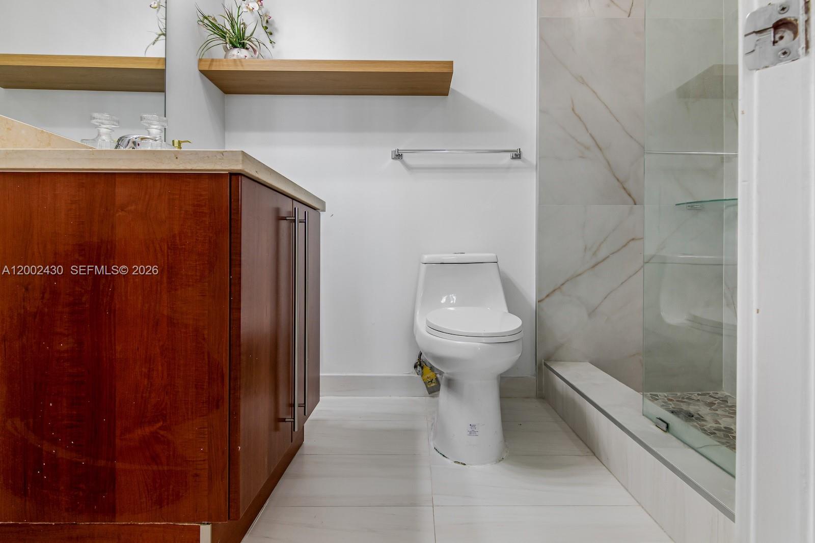 79 Southwest 12th Street, Unit 2107S Miami, FL 33130 - Photo 32 of 47 a bathroom with a sink and toilet