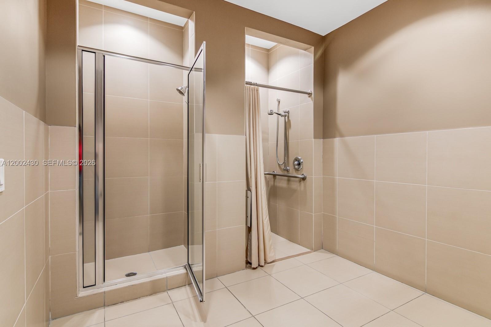 79 Southwest 12th Street, Unit 2107S Miami, FL 33130 - Photo 46 of 47 a bathroom with a shower and a mirror