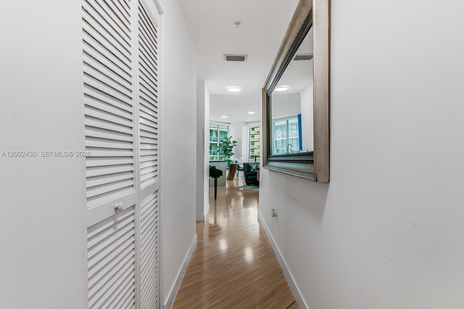 79 Southwest 12th Street, Unit 2107S Miami, FL 33130 - Photo 5 of 47 a view of a hallway view with wooden floor and staircase