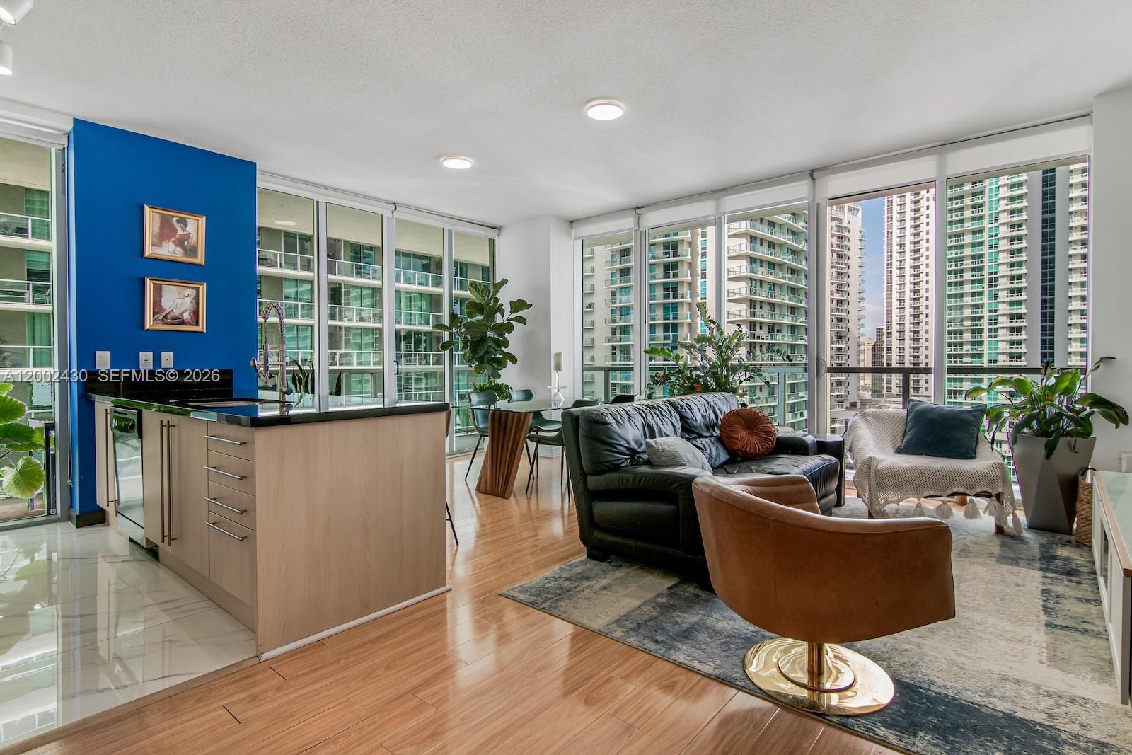 79 Southwest 12th Street, Unit 2107S Miami, FL 33130 - Photo 7 of 47 a living room with furniture and a potted plant