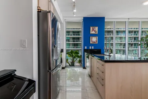 a kitchen with stainless steel appliances a sink stove and microwave