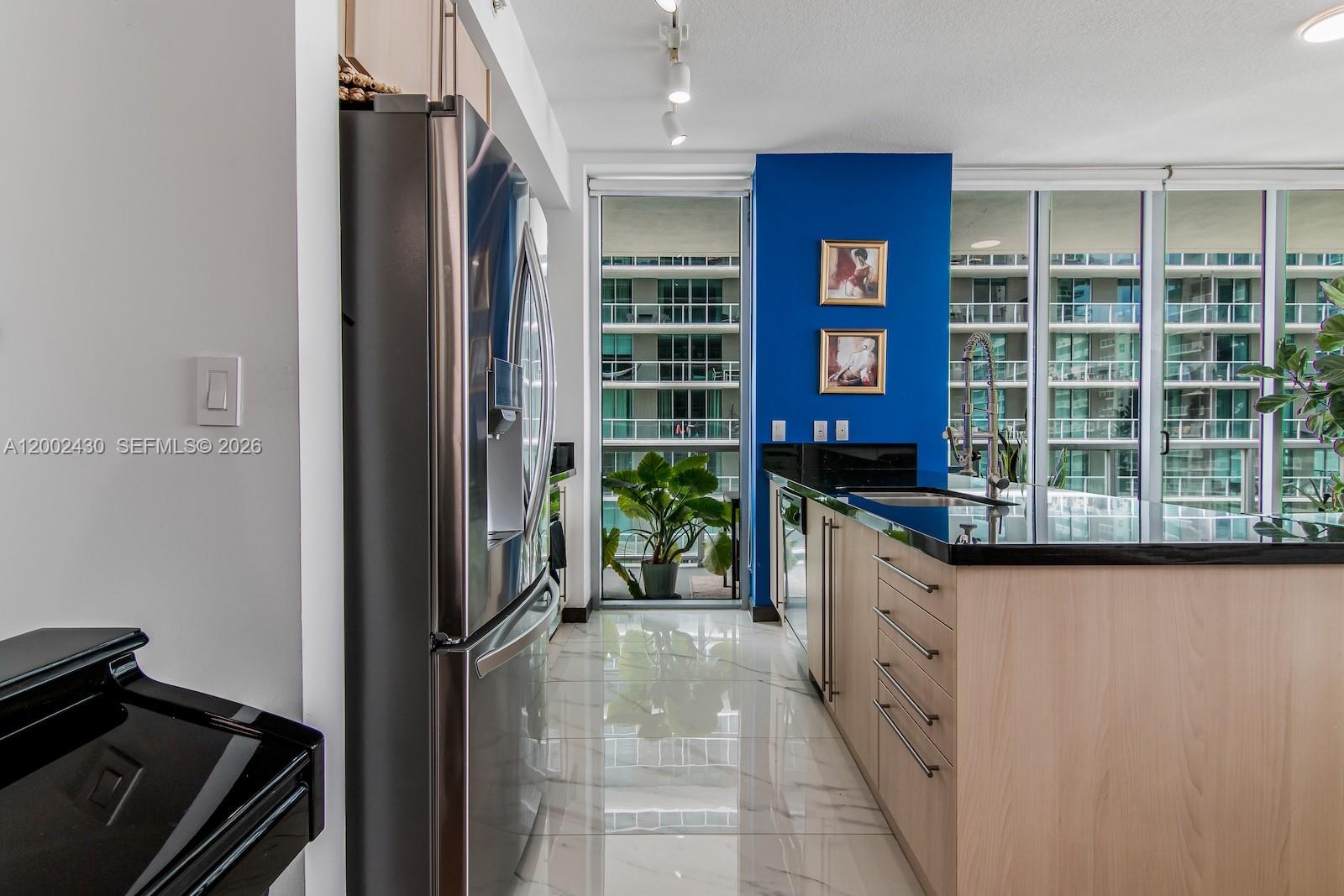 79 Southwest 12th Street, Unit 2107S Miami, FL 33130 - Photo 10 of 47 a view of a kitchen with granite countertop a oven and a sink