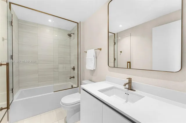 a kitchen with stainless steel appliances a dining table and chairs