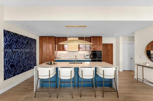 a kitchen with stainless steel appliances a sink a stove and a microwave