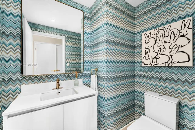 a bedroom with a large bed and a flat tv screen next to a window