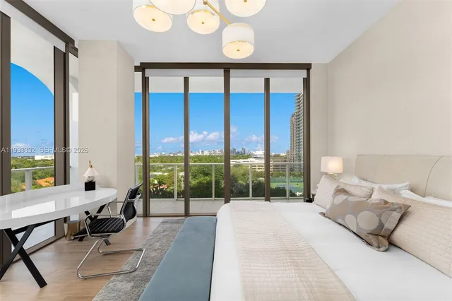 a bedroom with a bed tv and window