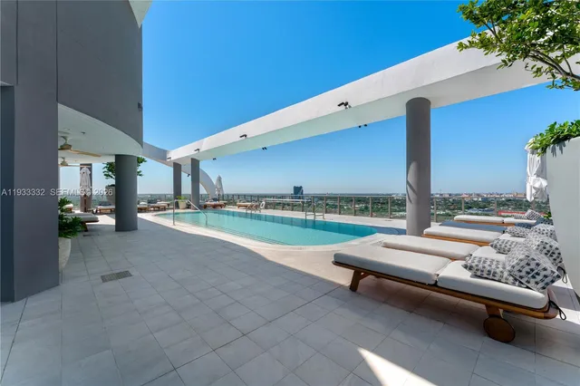 a view of a living room filled with lots of furniture and a view