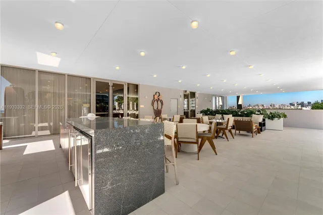 a swimming pool with outdoor seating and city view