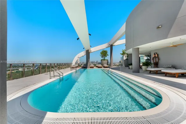 a view of a swimming pool and an outdoor seating