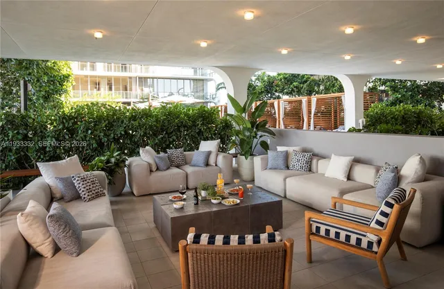 a living room with fireplace furniture and a potted plant