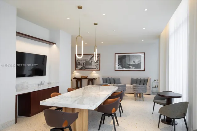 a living room with furniture a chandelier and a large mirror