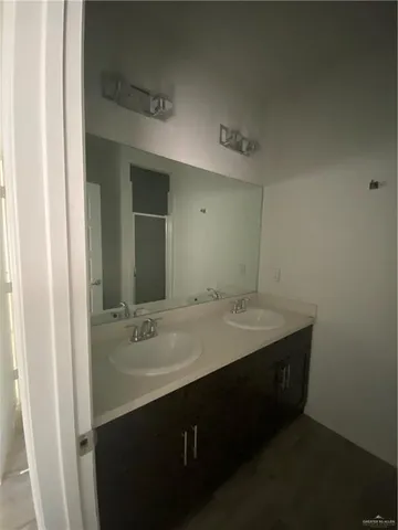 a bathroom with a sink vanity and mirror
