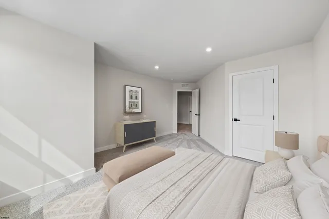 a bedroom with a large bed and a couch