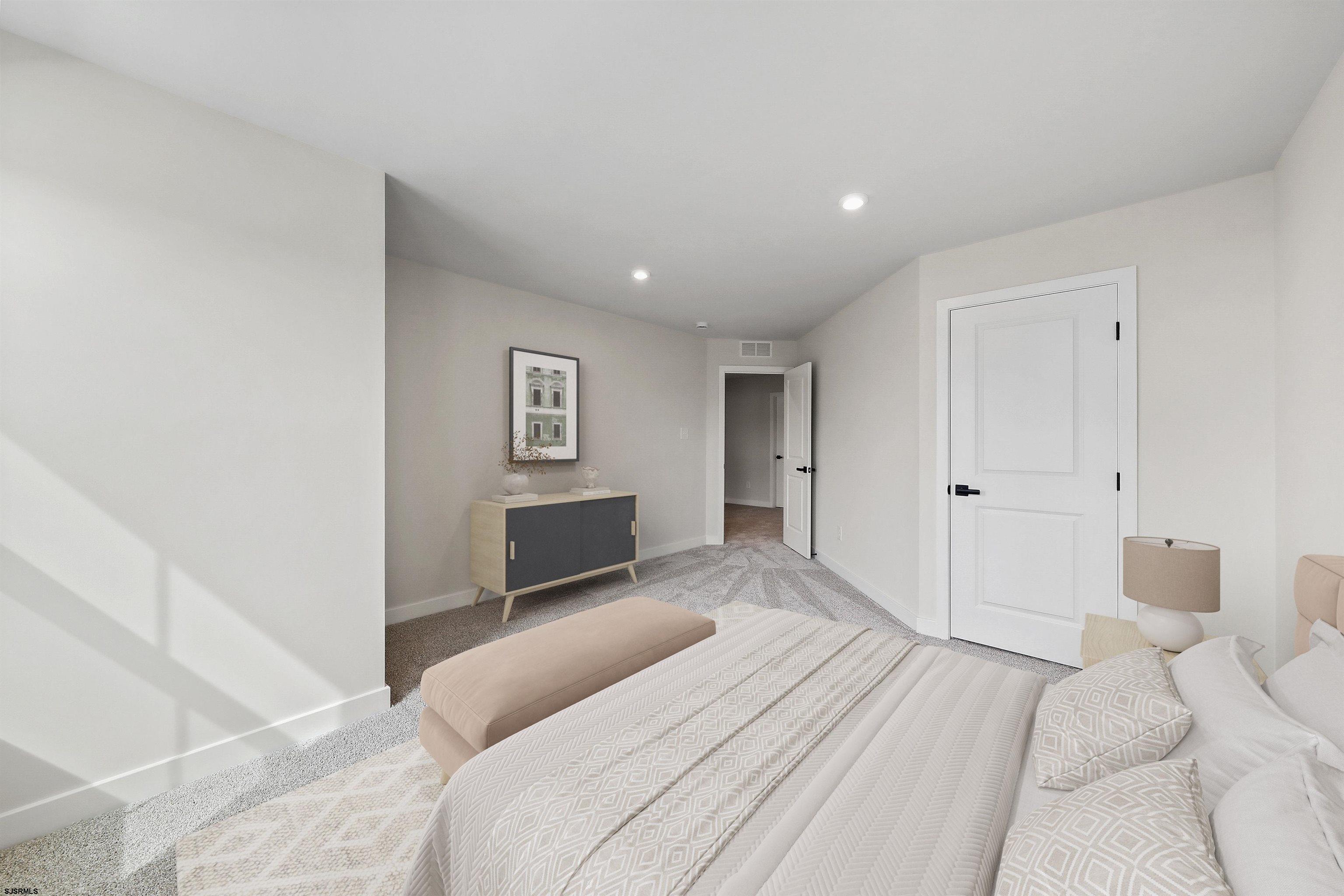 705 Jesse Drive, Unit 705 Somers Point, NJ 08244 - Photo 13 of 15 a bedroom with a large bed and a couch